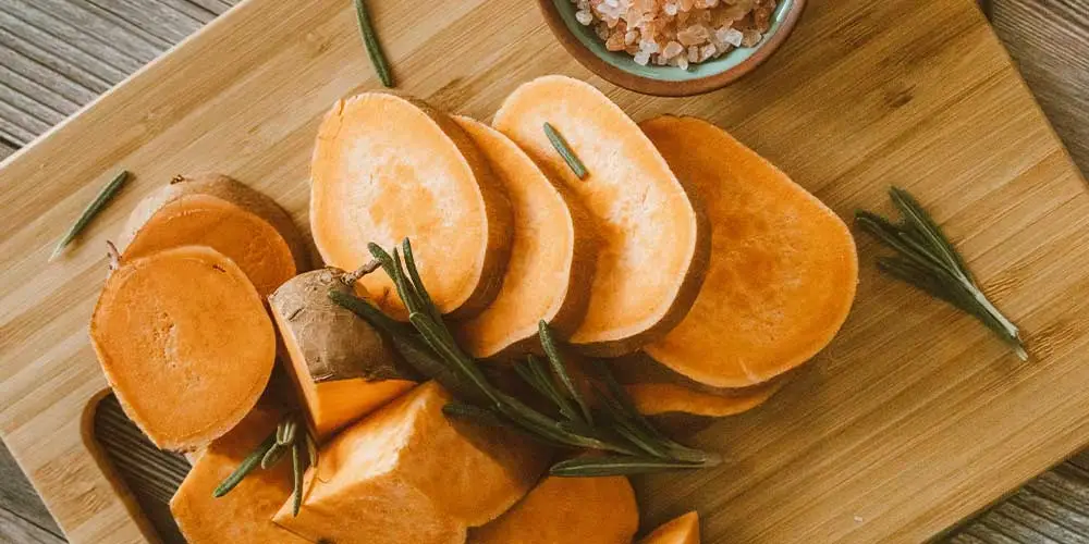 sliced sweet potatoes on a cutting board