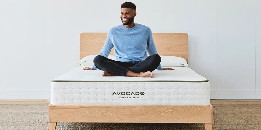 man sitting on organic mattress