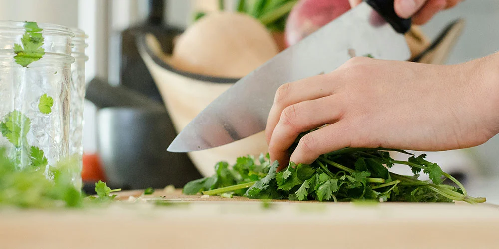 knife cutting cilantro